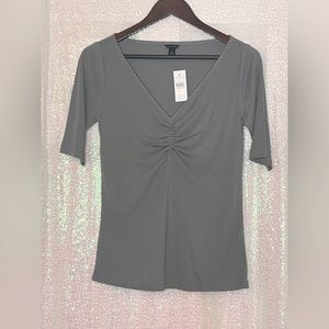Grey top with ruched bodice.